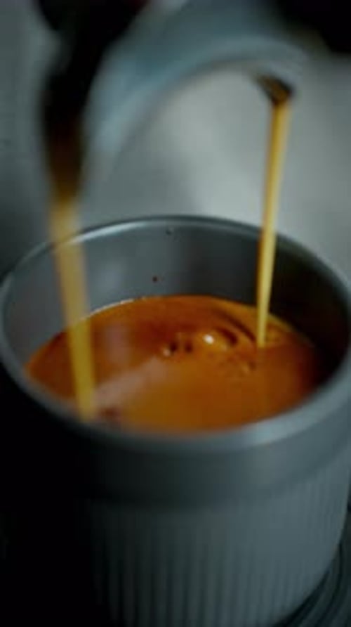 Espresso Streams Flowing into a Cup