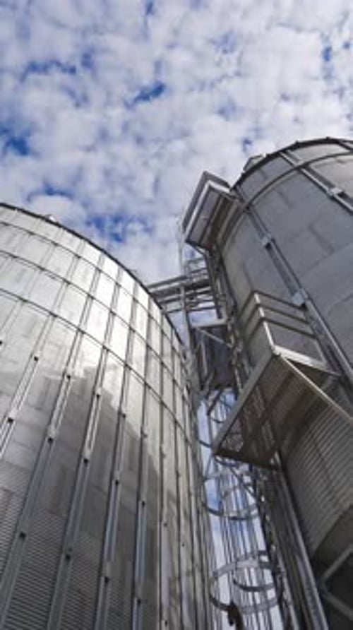 Grain elevator for storage of agricultural crops. Modern silos. Close-up. Vertical video