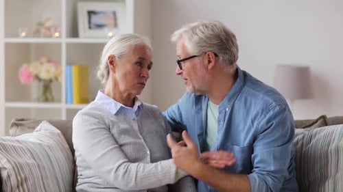 Senior Couple Embracing on Sofa in Living Room
