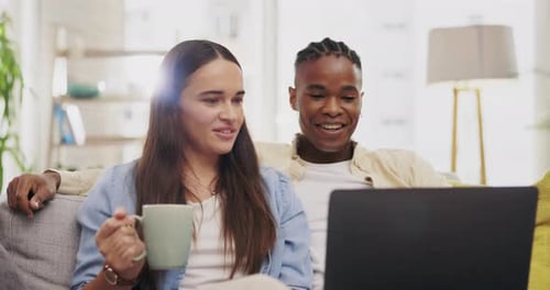 Couple Relaxing on Couch with Laptop Computer