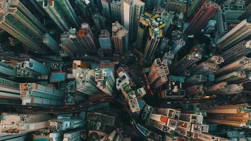 Drone shot, traveling backward, of a huge city with hundreds of skyscrapers during the day. It's an