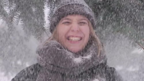 Portrait of a Young Woman on Whom Snow Falls From a Branch From Above