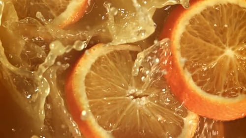 Juicy Orange Slices Splashing in Refreshing Liquid