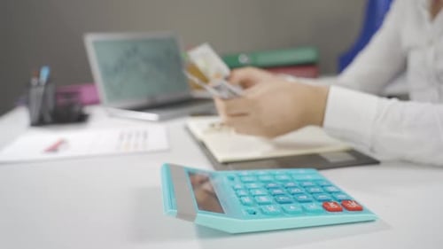 Businessman calculating salary calculates his economy.