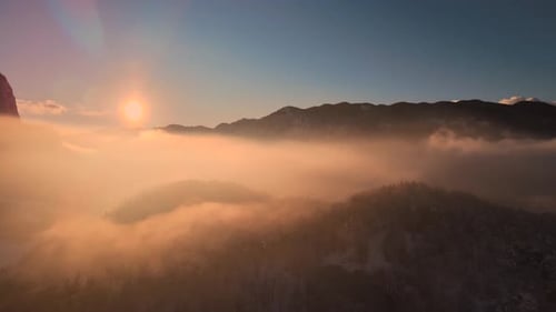 Mountain Peaks Emerging From Fog at Sunrise