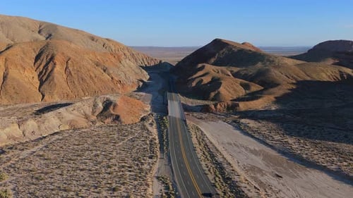 Breathtaking Aerial View of Desert Road Surrounded By Stunning Mountain Landscape