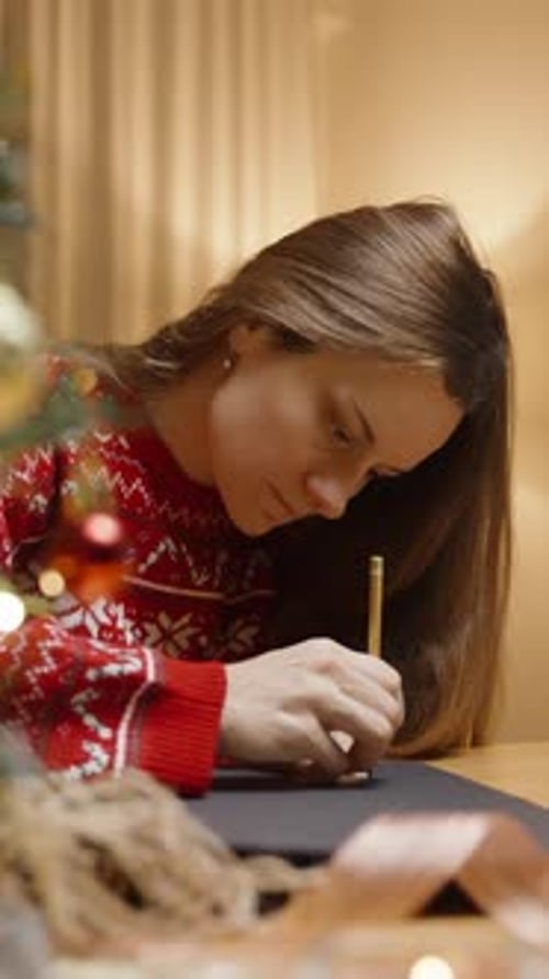 Woman Drawing Christmas Ornament at Home