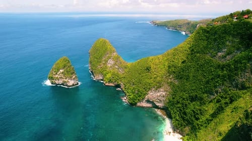 Exotic island on coastline of Bali Indonesia. Green tropical rainforest cliff Kelingking Beach with