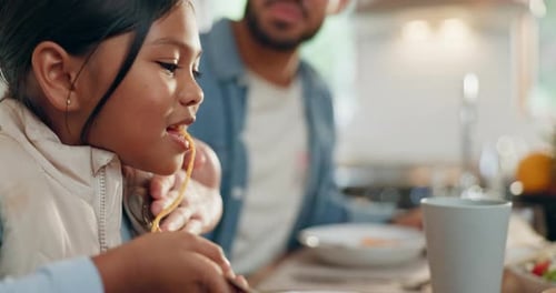 Girl Eating Spaghetti with Family at Home