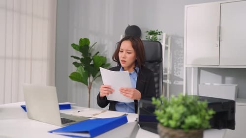 Frustrated Asian young businesswoman overwork late in office workplace.