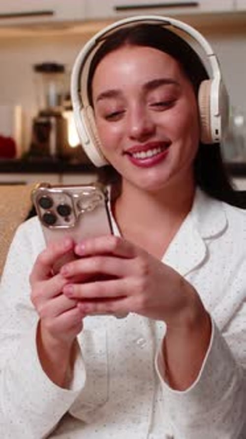 Woman Listening to Music and Using Phone