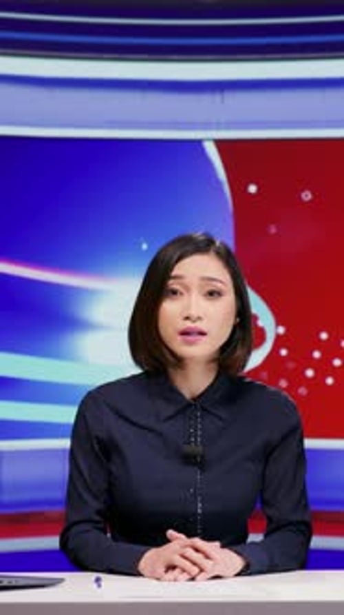 News Anchor in a Studio Delivering Report