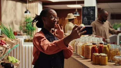 Zero Waste Store Employee Filming Their Natural Products in Recyclable Jars