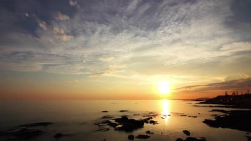 Sunset Sun and Clouds Over Sea