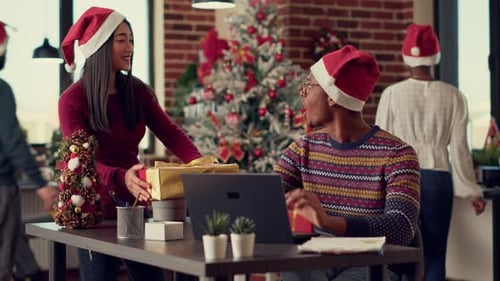 Diverse People Exchanging Christmas Gifts in Decorated Office