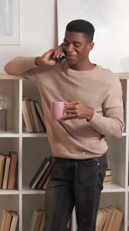 Young Adult Talking on Mobile Phone at Home