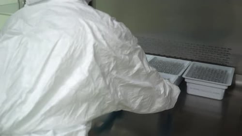 Pharmaceutical Manufacturing Technician Working in Laboratory Production Equipment at Pharmacy