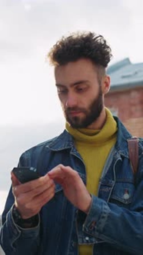 Young Adult Using Cell Phone in Urban Setting