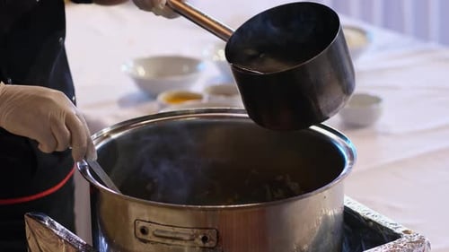 Pouring Water into the Cooking Pot