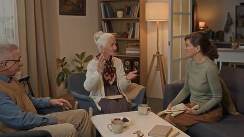 Three Friends Conversing in a Comfortable Living Room