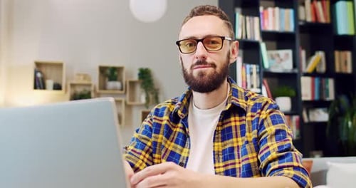 Man Working on Laptop in Home Office