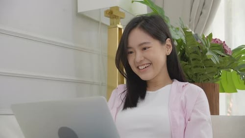 Woman Working on Laptop at Home, Smiling