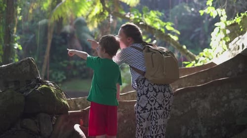 Woman and Boy Exploring Lush Tropical Forest