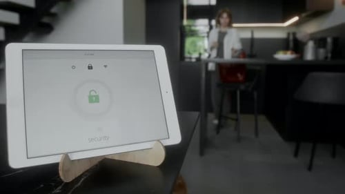 Woman Leaving Home and Smart App on Tablet Locking Doors