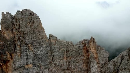 Aerial views of mountain range in the Dolomites, Italy, in a foggy day