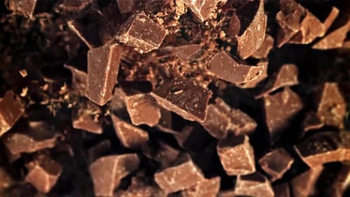 Dark Chocolate Pieces Flying in the Air