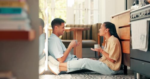 Couple Chatting and Drinking Tea in Kitchen