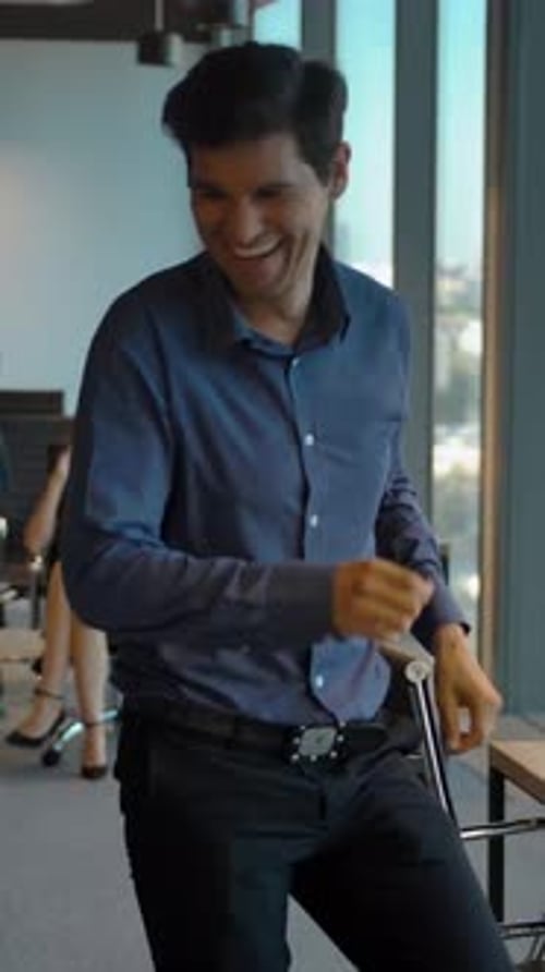 Vertical of Attractive Confident Colleagues Celebrating with Dance in Their Office