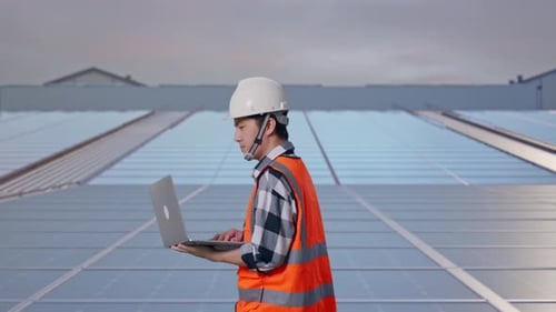Asian Male Use Computer While Walking at Rooftop Solar