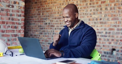 Building, fist pump and laptop with black man on construction site for planning goals or target