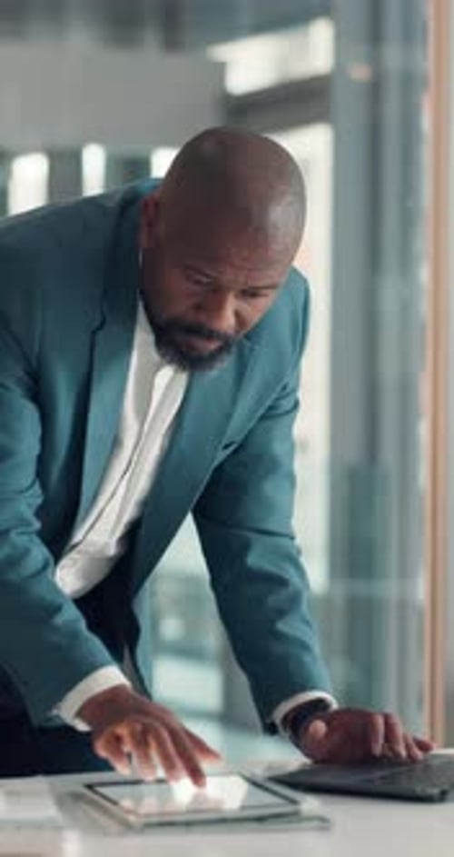 Tablet, laptop and business man in office for finance review, investment research and stock market