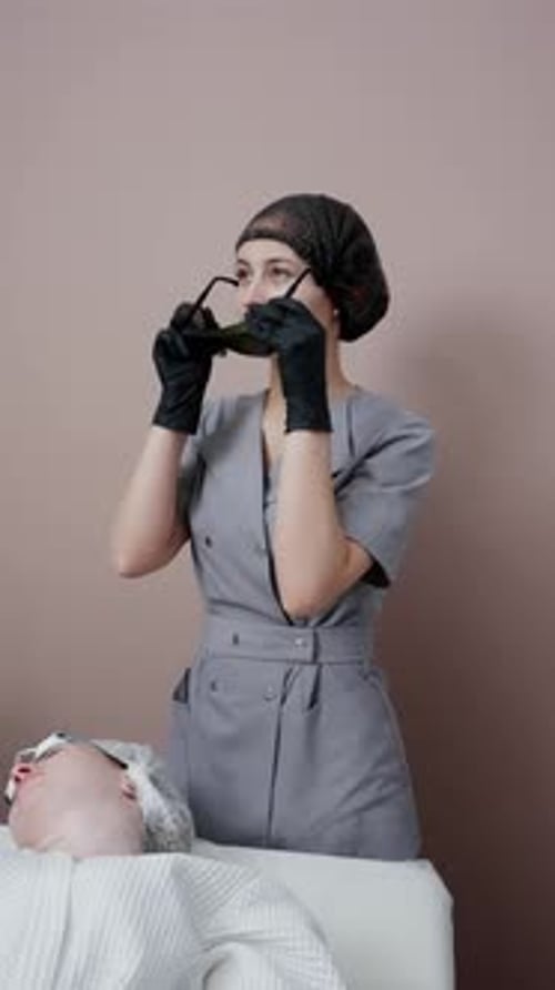 Healthcare Professional with Protective Eyewear Preparing for Treatment