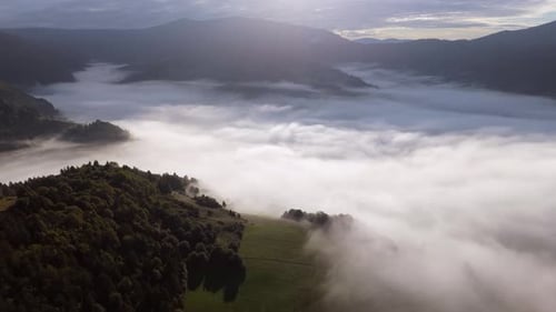 Aerial Video Misty Landscape Over Lush Green Valley at Dawn A Breathtaking View of a Misty Landscape