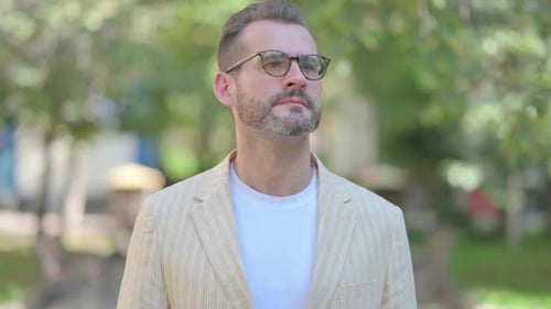 Bearded Man Searches in an Urban Park