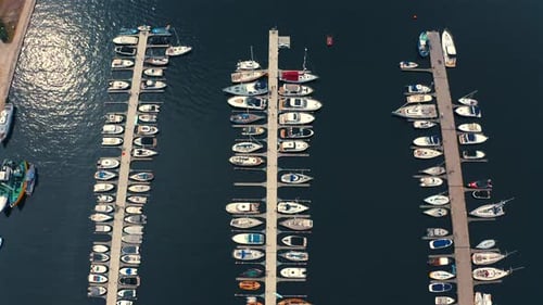 Drone top view looking on luxurious yachts and motorboats moored in the marina