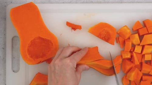 Person Dicing Butternut Squash on Cutting Board