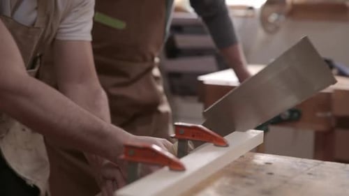 Carpenters Cutting Wood with Pull Saw in Workshop 3539 Years