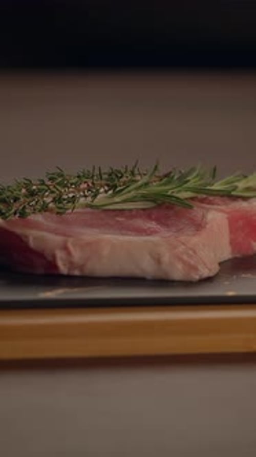 Deliciously Freshly Prepared Steak Infused with Aromatic Herbs on a Rustic Wooden Board