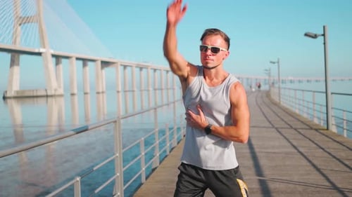 Sporty Male Athlete Doing Stretching Exercise on Bridge