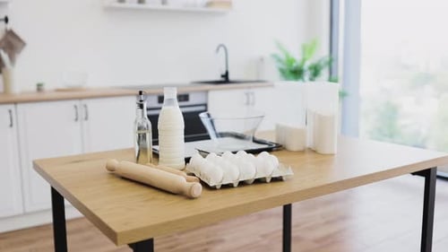 Cooking Ingredients Arranged on Wooden Kitchen Table with Bright Background View