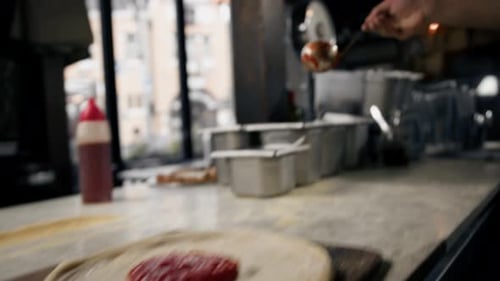 Professional chef makes traditional margarita pizza add tomato paste, cheese on pizza