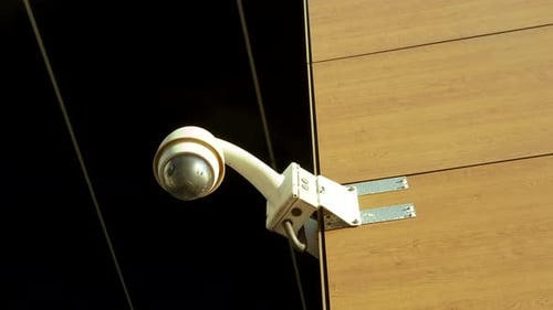 Surveillance camera mounted on a building wall - city security