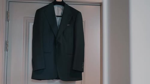 Elegant Dark Suit Hanging on Door for Wedding