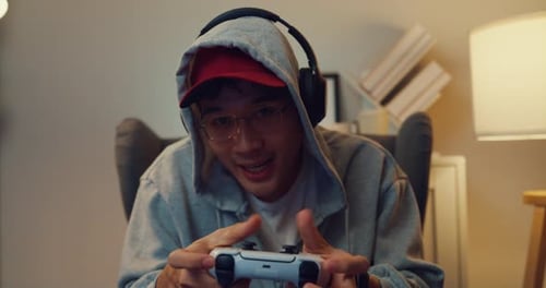 Young Man Plays Video Games Indoors