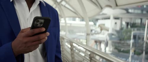 Crop View of African American Businessman Hands Text on Smartphone