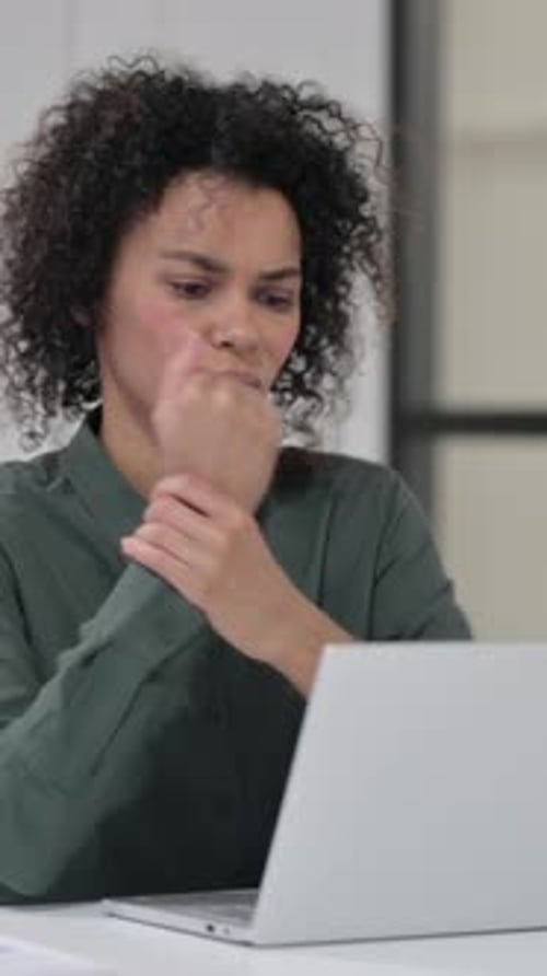 Woman experiencing wrist pain while using laptop